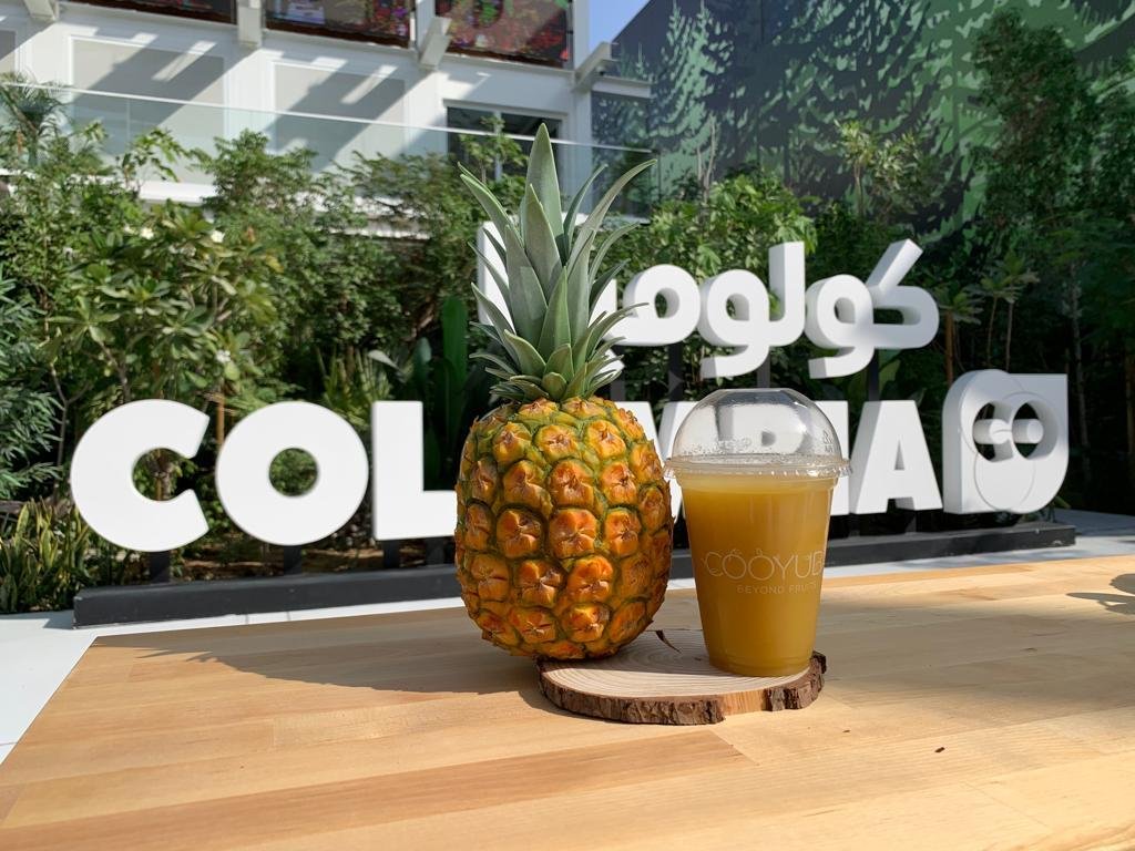 Pineapple and fresh juice in front of the Colombia sign at Expo Dubai