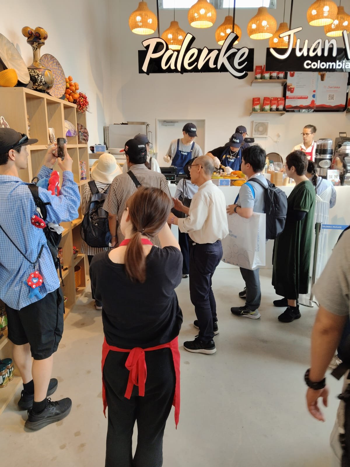 Visitors at the Palenke shop and Juan Valdez counter in the Colombia pavilion at Expo Osaka 2025