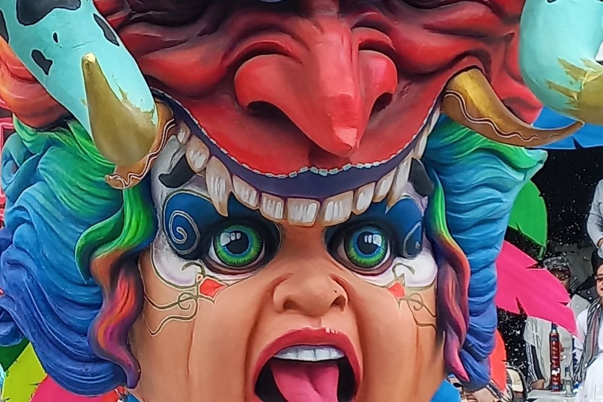 Close-up of a giant painted mask on a carnival float in Pasto