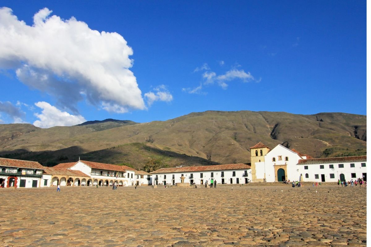 Cobblestone Plaza Mayor of Villa de Leyva with the parish church and mountains behind