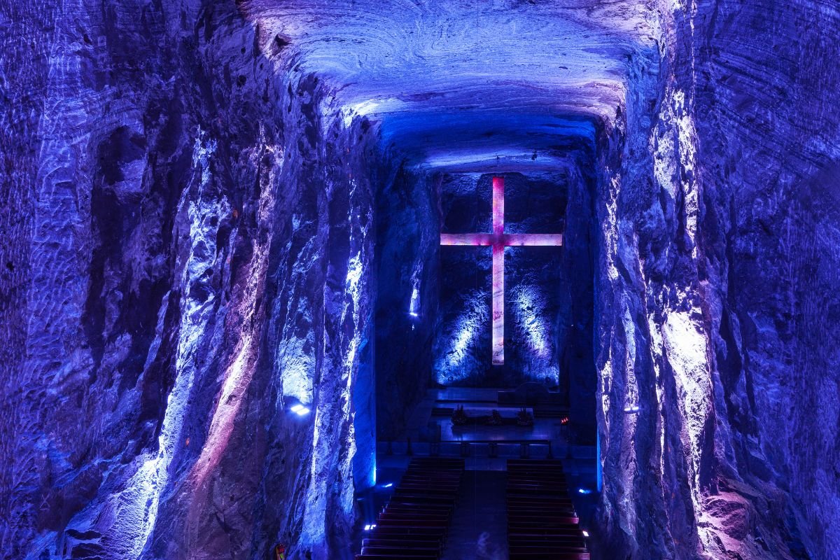 Illuminated cross in the blue-lit main nave of the Salt Cathedral of Zipaquirá