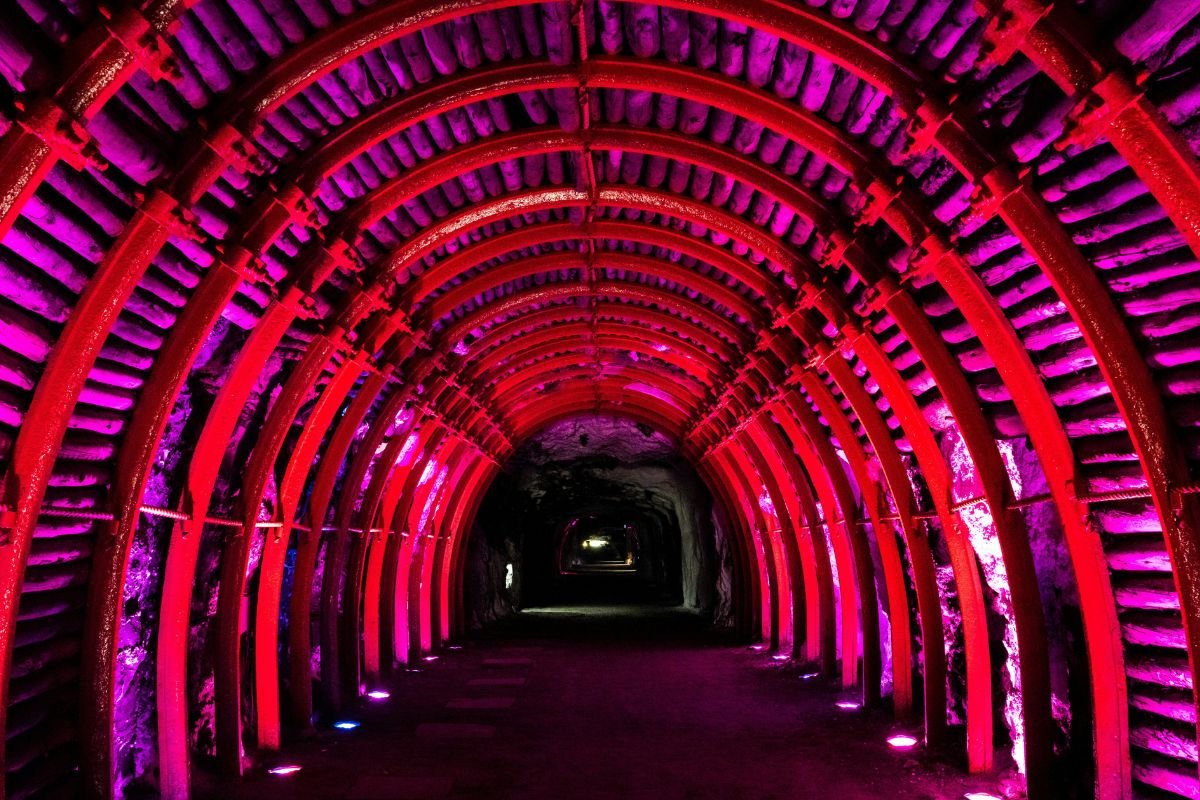 Red-lit arched tunnel leading into the Salt Cathedral of Zipaquirá